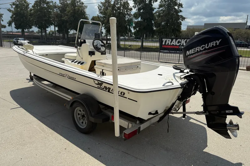 Slide: The Image of 2013 Mako Pro Skiff 17 CC boat with Mercury engine on trailer. - 5