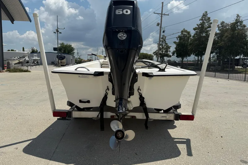Slide: The Image of 2013 Mako Pro Skiff 17 CC boat on trailer, rear view with outboard motor. - 6