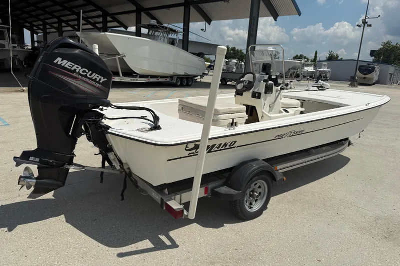 Slide: The Image of 2013 Mako Pro Skiff 17 CC boat with Mercury outboard motor on trailer. - 7