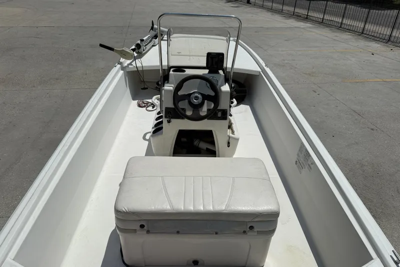 Slide: The Image of 2013 Mako Pro Skiff 17 CC boat interior with steering console and seating. - 8