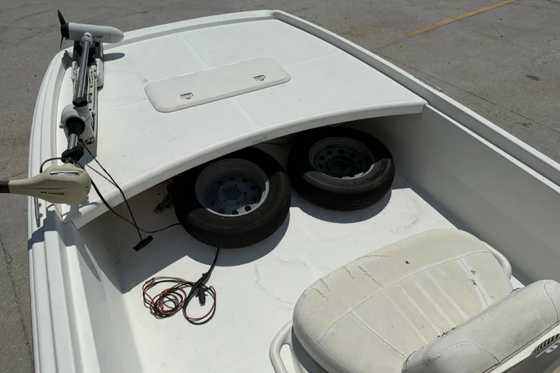 Slide: The Image of 2013 Mako Pro Skiff 17 CC boat deck with trolling motor and spare tires. - 9