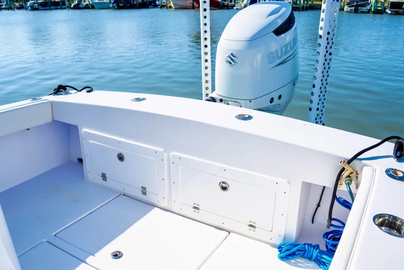 Slide: The Image of 1979 SeaCraft SF23 boat with Suzuki outboard motor on calm water. - 10