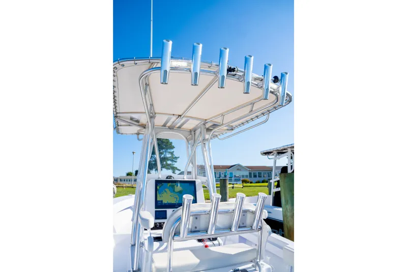 Slide: The Image of 1979 SeaCraft SF23 boat with T-top and rod holders, featuring a navigation screen. - 11