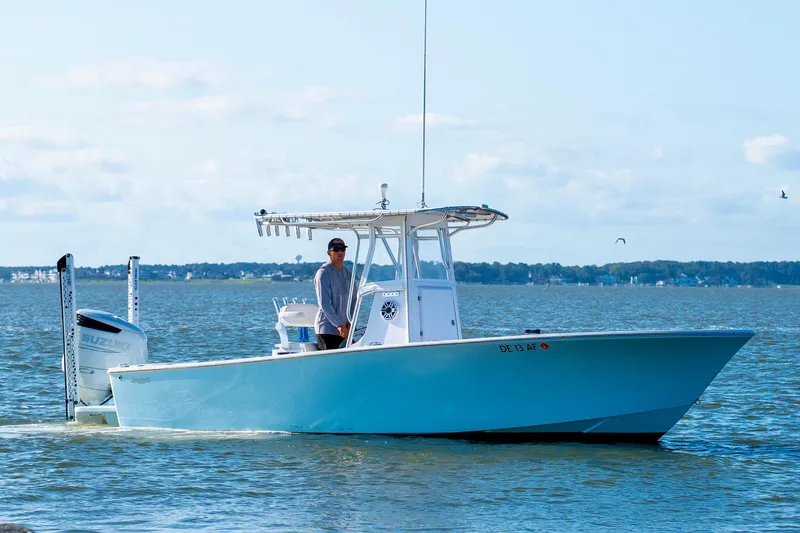 Slide: The Image of 1979 SeaCraft SF23 boat cruising on calm waters with a clear sky backdrop. - 3