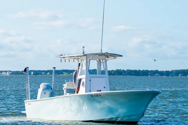 Slide: The Image of 1979 SeaCraft SF23 boat on calm water with distant shoreline. - 4