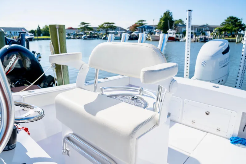 Slide: The Image of 1979 SeaCraft SF23 boat with white seating, docked near water, featuring Mercury and Suzuki engines. - 6