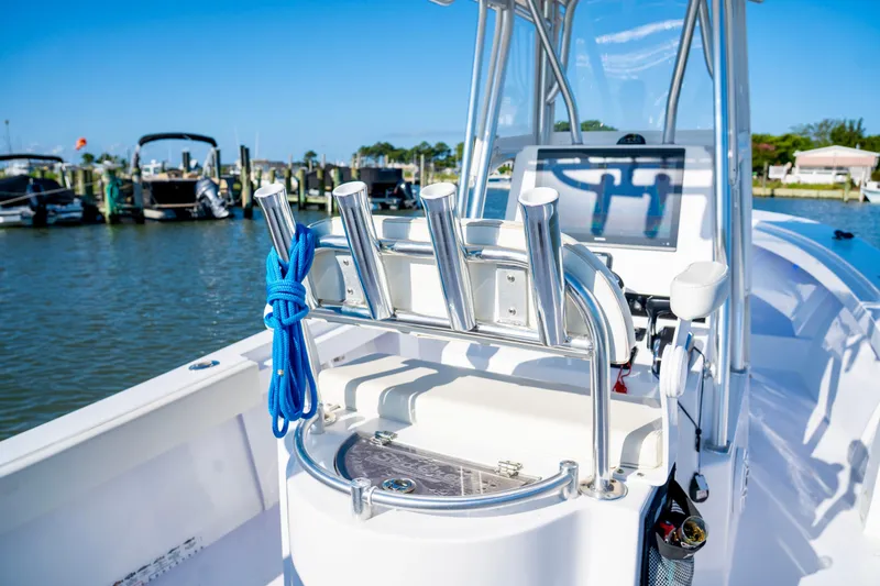 Slide: The Image of 1979 SeaCraft SF23 boat with rod holders and blue rope, docked at marina. - 7