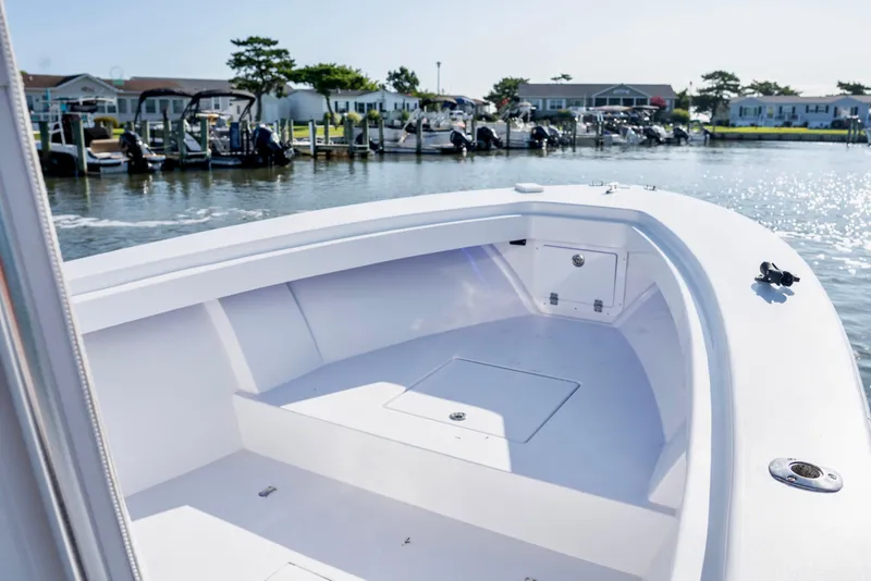 Slide: The Image of 1979 SeaCraft SF23 boat docked at a marina, showcasing spacious deck and storage. - 9