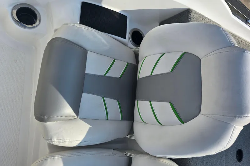 Slide: The Image of 2020 Nitro Z19 Sport boat seats with gray and green accents, cup holder visible. - 14