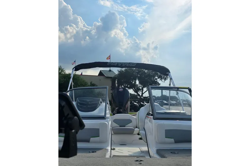 Slide: The Image of 2020 Nitro Z19 Sport boat with canopy under a cloudy sky. - 2