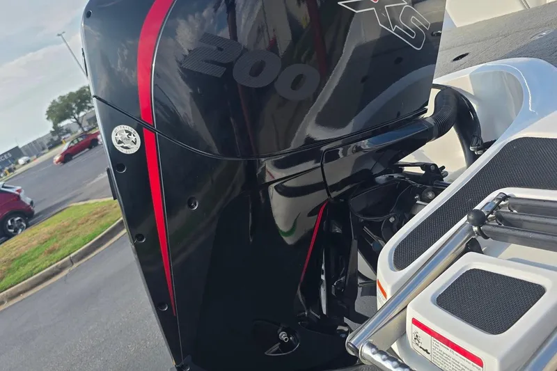 Slide: The Image of 2020 Nitro Z19 Sport boat engine with red accents in a parking lot. - 3