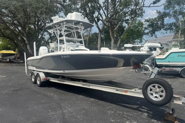 The Image of 2018 Crevalle 26 HBW boat on trailer, parked outdoors with trees in background. - 0