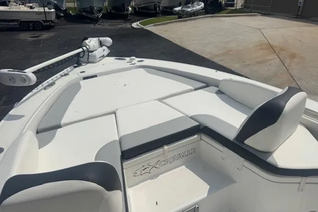 Slide: The Image of 2018 Crevalle 26 HBW boat with cushioned seating and trolling motor on deck. - 11