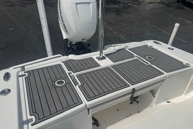 Slide: The Image of 2018 Crevalle 26 HBW boat deck with non-slip surface and outboard motor. - 15