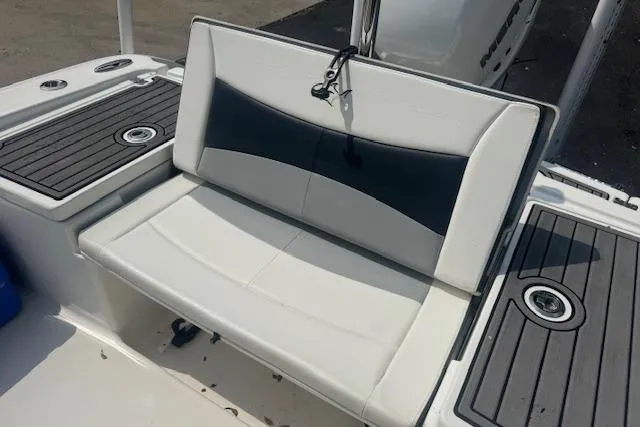 Slide: The Image of 2018 Crevalle 26 HBW boat seating with black and white cushioned bench. - 16