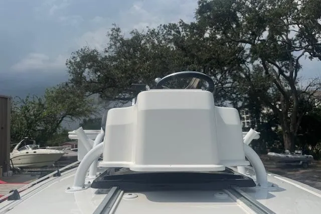 Slide: The Image of 2018 Crevalle 26 HBW boat console with trees and cloudy sky in the background. - 18