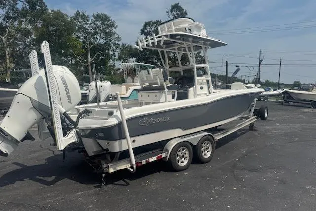 Slide: The Image of 2018 Crevalle 26 HBW boat on trailer, parked outdoors, featuring dual engines. - 3