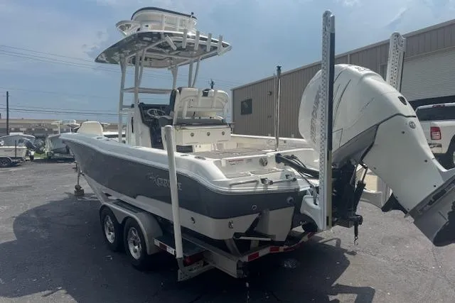 Slide: The Image of 2018 Crevalle 26 HBW boat on trailer, featuring dual engines and T-top. - 6