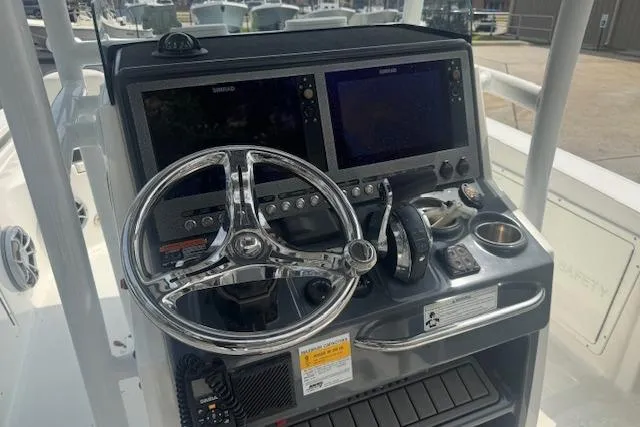 Slide: The Image of 2018 Crevalle 26 HBW boat dashboard with dual screens and steering wheel. - 9