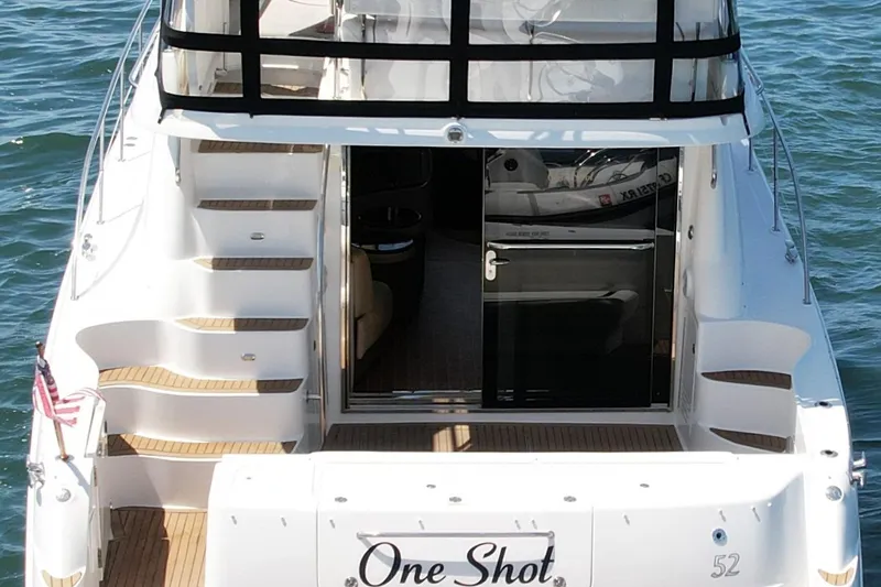 Slide: The Image of 2007 Sea Ray 52 Sedan Bridge yacht with open deck and stairs, named "One Shot." - 12