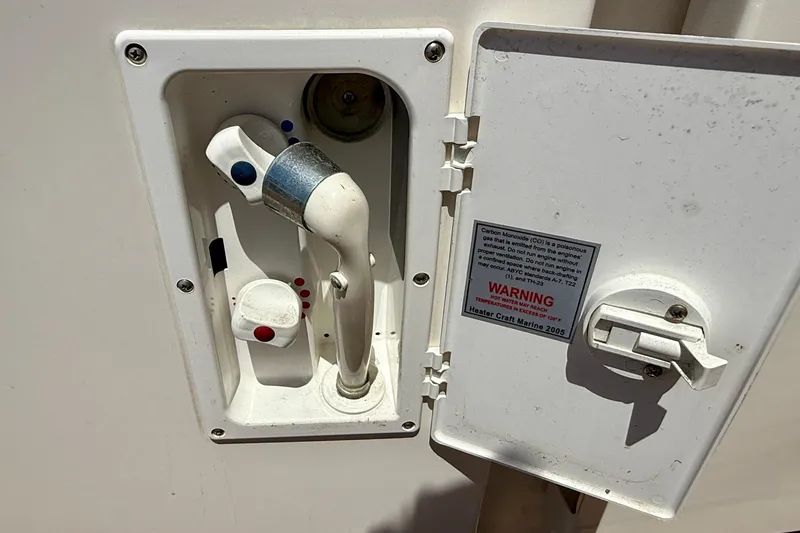 Slide: The Image of 2007 Sea Ray 52 Sedan Bridge shower control panel with warning label. - 19