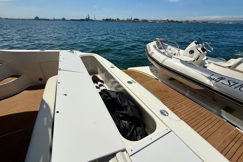 Slide: The Image of 2007 Sea Ray 52 Sedan Bridge yacht with tender, docked on calm waters. - 20