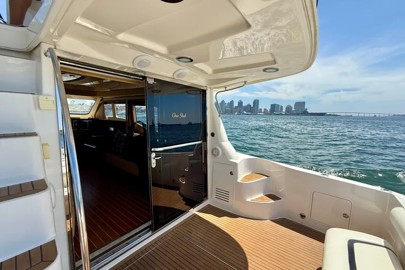 Slide: The Image of 2007 Sea Ray 52 Sedan Bridge yacht with city skyline view, featuring elegant interior and deck. - 22