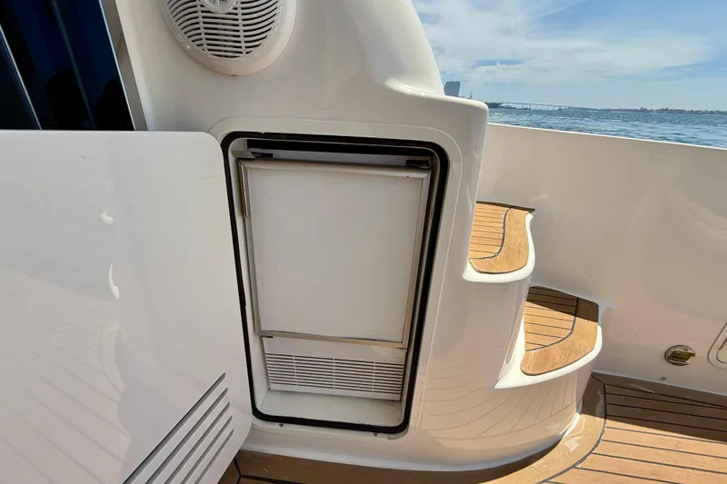 Slide: The Image of 2007 Sea Ray 52 Sedan Bridge yacht with outdoor fridge and wooden steps. - 24
