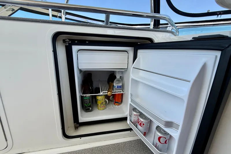Slide: The Image of Mini fridge on 2007 Sea Ray 52 Sedan Bridge, stocked with drinks. - 29