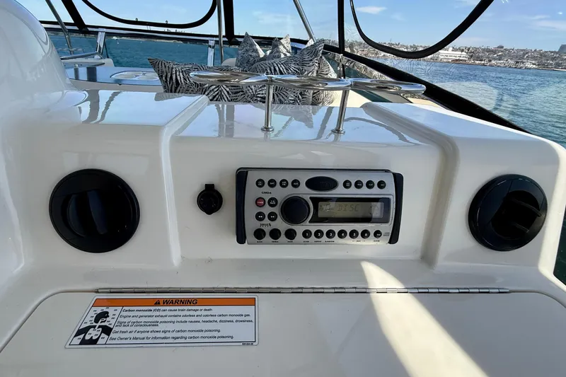 Slide: The Image of 2007 Sea Ray 52 Sedan Bridge dashboard with stereo system and warning label. - 37