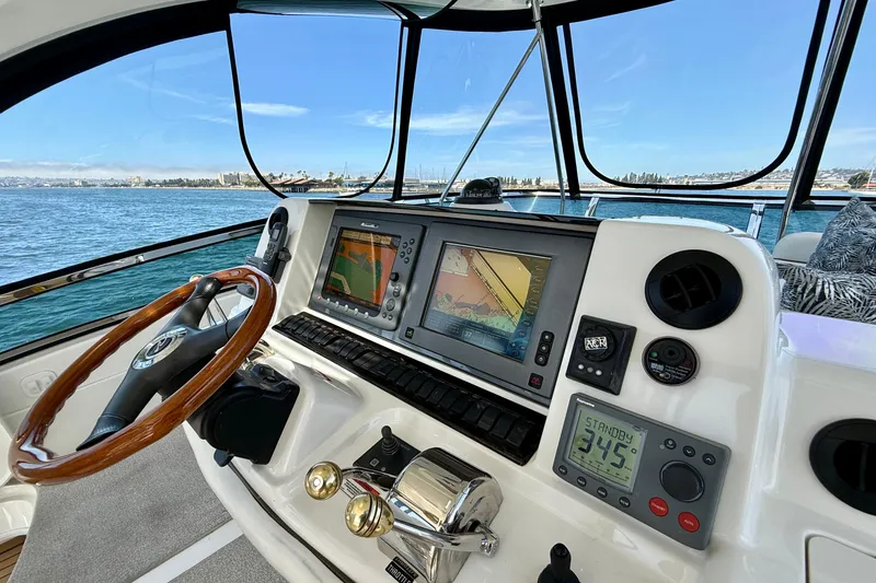 Slide: The Image of Helm of 2007 Sea Ray 52 Sedan Bridge with navigation screens and controls, overlooking the ocean. - 38