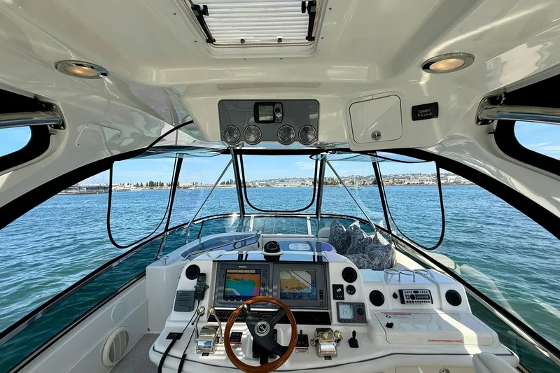 Slide: The Image of 2007 Sea Ray 52 Sedan Bridge helm with navigation equipment and ocean view. - 40
