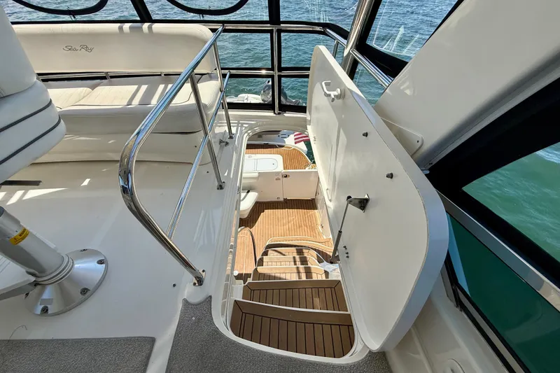 Slide: The Image of 2007 Sea Ray 52 Sedan Bridge interior with stairs and seating, overlooking water. - 42