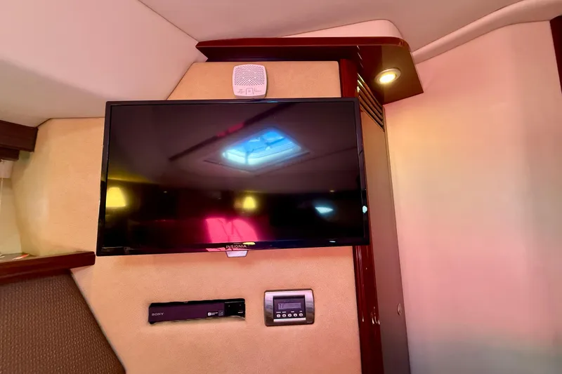 Slide: The Image of Flat-screen TV and control panel inside 2007 Sea Ray 52 Sedan Bridge yacht cabin. - 47