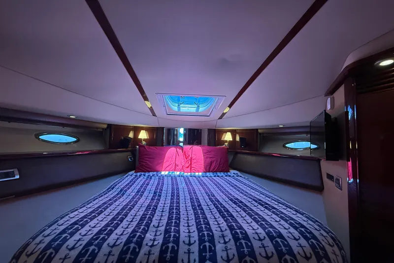 Slide: The Image of Luxurious 2007 Sea Ray 52 Sedan Bridge yacht bedroom with nautical-themed bedding. - 49