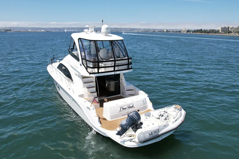 Slide: The Image of 2007 Sea Ray 52 Sedan Bridge yacht cruising on open water, rear view. - 5