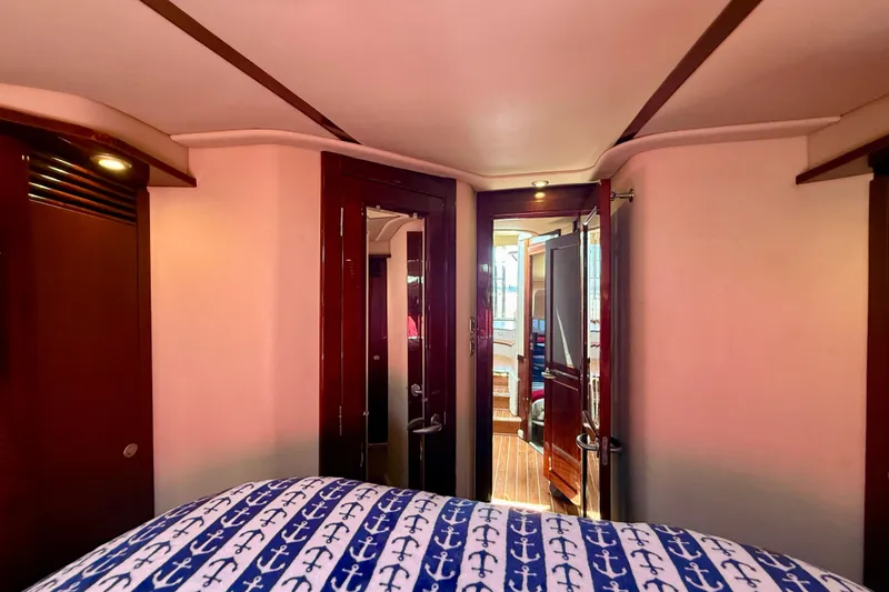 Slide: The Image of Interior of 2007 Sea Ray 52 Sedan Bridge yacht with nautical-themed bedding. - 50