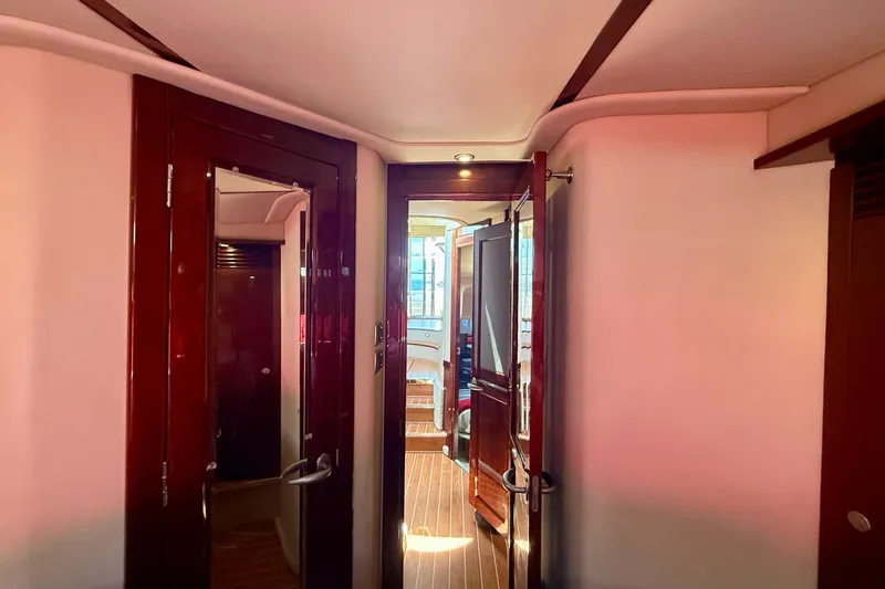 Slide: The Image of Interior hallway of 2007 Sea Ray 52 Sedan Bridge yacht with wooden doors and flooring. - 51