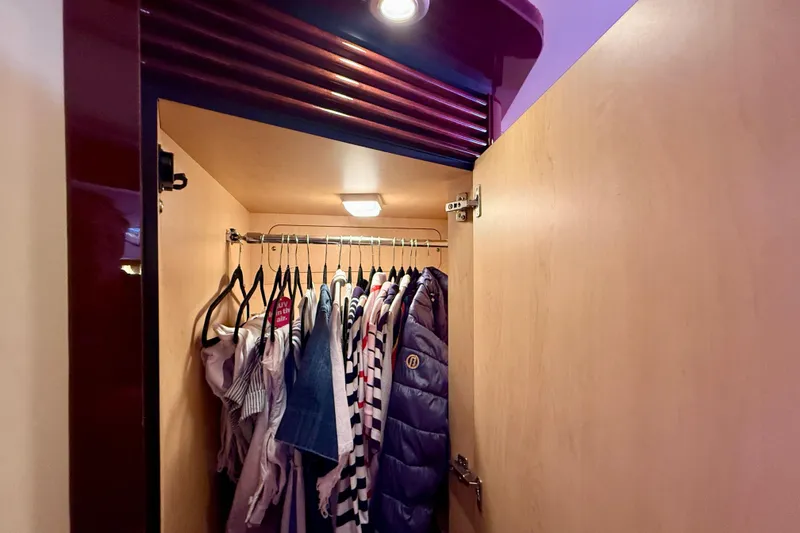 Slide: The Image of Closet interior on 2007 Sea Ray 52 Sedan Bridge yacht with hanging clothes. - 52
