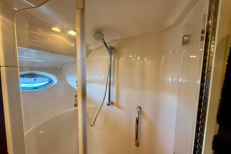 Slide: The Image of Shower area in 2007 Sea Ray 52 Sedan Bridge yacht with porthole and handheld showerhead. - 54