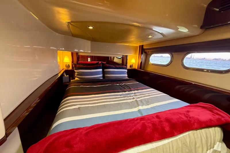 Slide: The Image of Luxurious cabin interior of 2007 Sea Ray 52 Sedan Bridge yacht with striped bedding. - 55