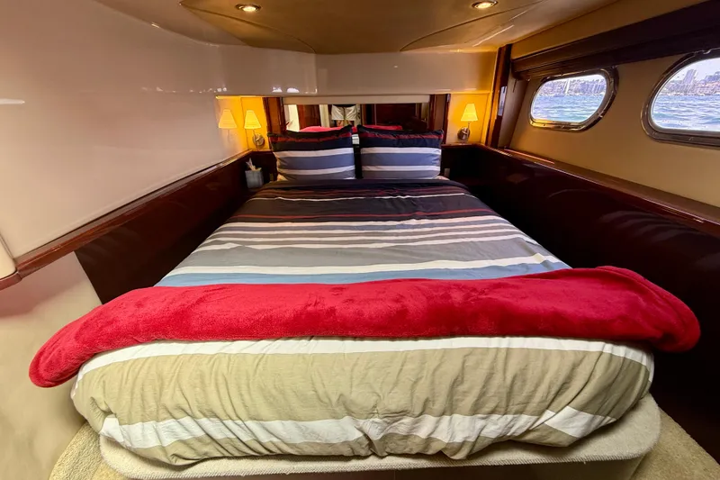 Slide: The Image of Luxurious bedroom interior of 2007 Sea Ray 52 Sedan Bridge yacht with striped bedding. - 59