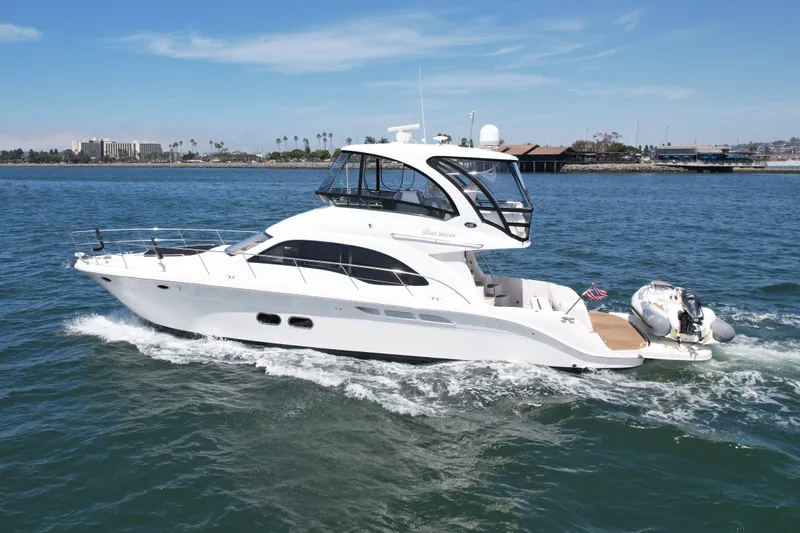 Slide: The Image of 2007 Sea Ray 52 Sedan Bridge yacht cruising on open water. - 6