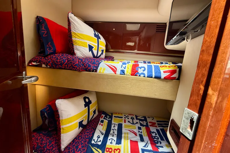 Slide: The Image of Bunk beds with nautical-themed bedding in 2007 Sea Ray 52 Sedan Bridge yacht cabin. - 62