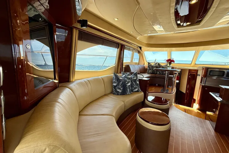 Slide: The Image of Luxurious interior of a 2007 Sea Ray 52 Sedan Bridge yacht with elegant seating and panoramic windows. - 65
