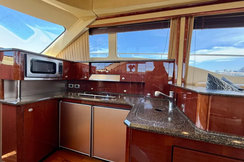 Slide: The Image of Luxurious kitchen interior of 2007 Sea Ray 52 Sedan Bridge yacht with modern amenities. - 69
