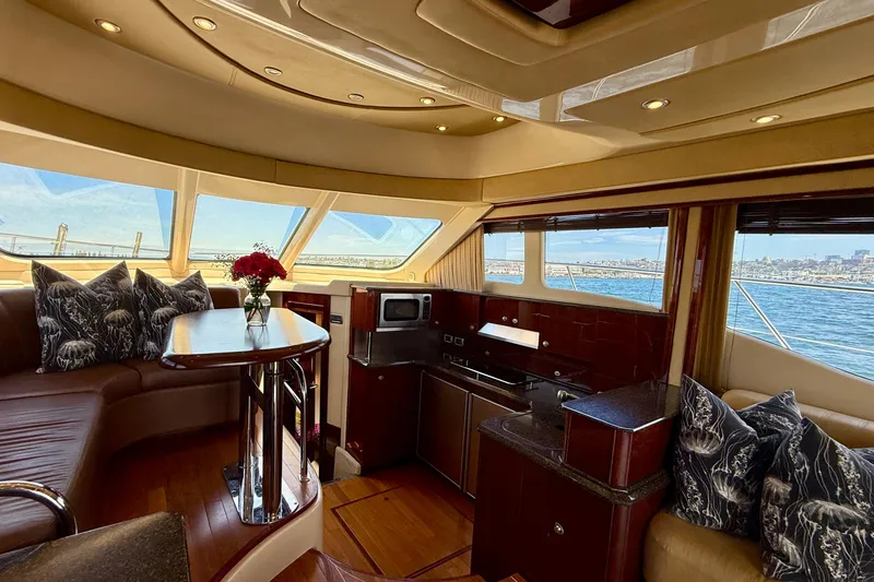 Slide: The Image of Luxurious interior of a 2007 Sea Ray 52 Sedan Bridge yacht with elegant seating and kitchen. - 72