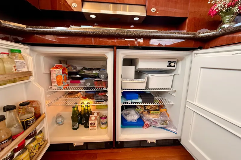 Slide: The Image of Open refrigerator in 2007 Sea Ray 52 Sedan Bridge yacht kitchen, stocked with various food and drinks. - 73