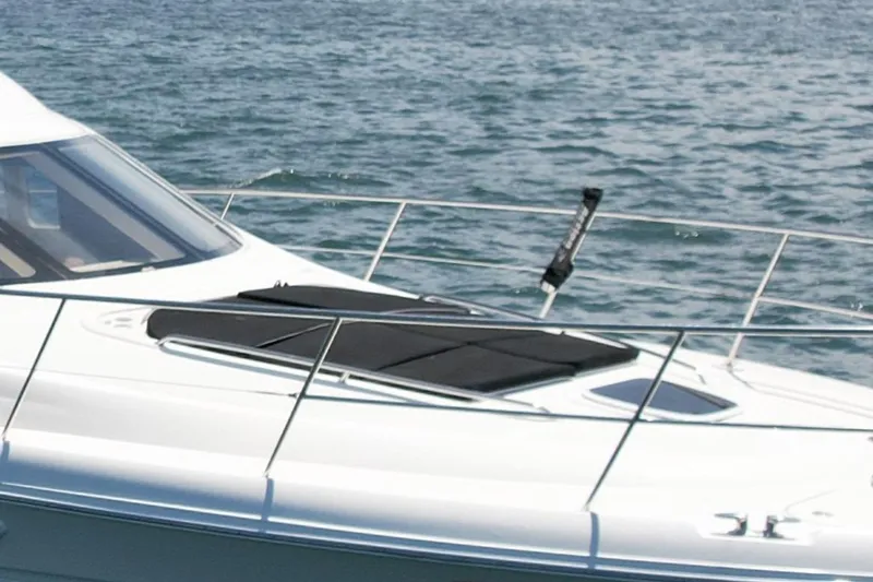 Slide: The Image of 2007 Sea Ray 52 Sedan Bridge yacht on water, featuring sleek design and sunbathing area. - 9