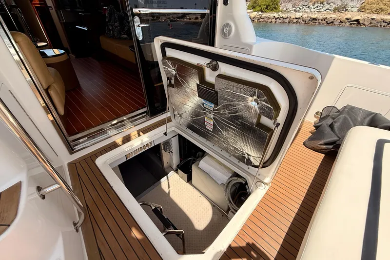 Slide: The Image of 2007 Sea Ray 52 Sedan Bridge yacht interior with open hatch and wooden flooring. - 93